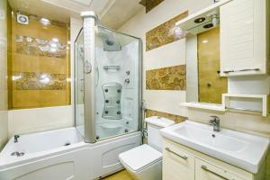 a bathroom with a shower and a toilet and a sink at Apartment BİCOCCA in Baku +22 photos