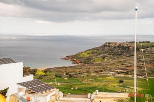 a view of the ocean from a house with solar panels at The Segond Hotel in Xagħra