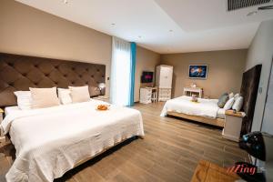 a bedroom with two beds with white sheets at The Segond Hotel in Xagħra