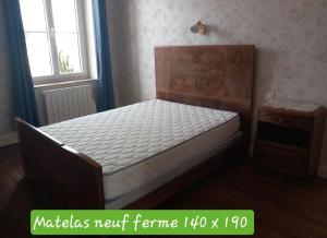 A bed or beds in a room at Gite de Chassigny