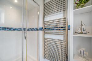 a bathroom with a shower with a glass door at No 26 The Salcombe in Salcombe