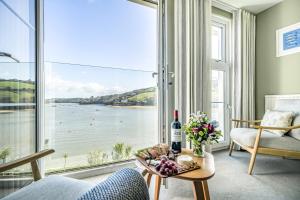 a living room with a view of the water at No 26 The Salcombe in Salcombe +46 photos