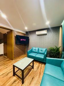a waiting room with a couch and a table at Nexstay Bloomax Residency in Malappuram