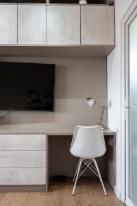 a white desk with a chair and a lamp at Sunset - Luxury Studio on Calea Victoriei in Bucharest