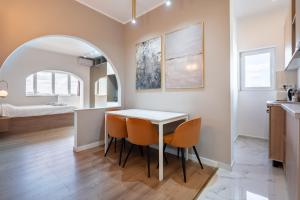 a kitchen and dining room with a table and chairs at Sunset - Luxury Studio on Calea Victoriei in Bucharest