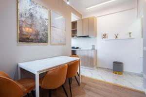 a kitchen and dining room with a table and chairs at Sunset - Luxury Studio on Calea Victoriei in Bucharest