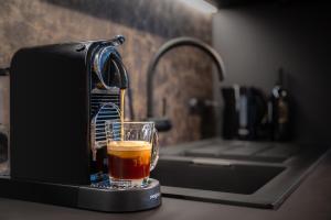 a drink is being poured into a glass at The Studio in Antwerp