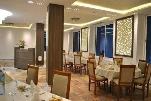 a dining room with tables and chairs in a restaurant at Rym El Djamil Hotel in Annaba