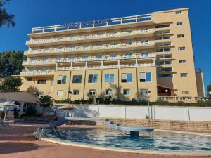 a large building with a pool in front of a building at Rym El Djamil Hotel in Annaba