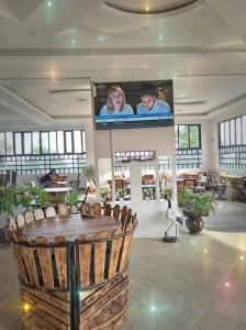 a large room with a flat screen tv on the wall at The Grand Alton Resort in Kisumu