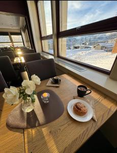 a table with a plate of food on top of it at Hotell Maritim Skjervoy in Skjervøy +41 photos