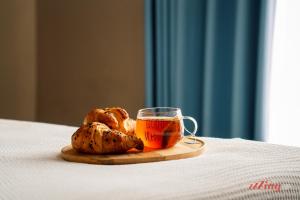 a plate of bread and a cup of tea on a table at The Segond Hotel in Xagħra