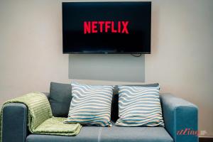 a blue couch with a television on the wall at The Segond Hotel in Xagħra