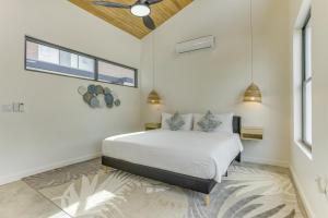 a white bedroom with a bed and a window at Villa Cascada at Beyond the Blue in Seine Bight Village +68 photos