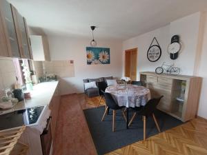 a kitchen and dining room with a table and chairs at Stan na dan Relax in Bosanska Dubica