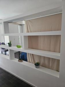 a shelf in a room with potted plants on it at Casa Vacanze MELA in Borghesiana 
