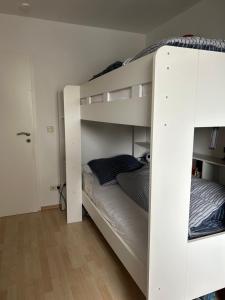 a white bunk bed in a white room at Ferienwohnung Theodor - Wandern am Biggesee in Attendorn