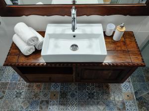 a bathroom sink on a wooden table with towels at Casa Centrale in Apollonia