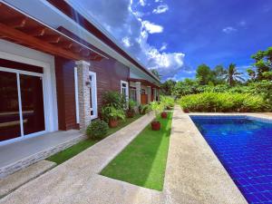 a house with a swimming pool next to a house at Diver Inn in Panglao
