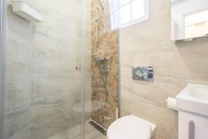a bathroom with a shower with a toilet and a sink at Katica's Ribnjak Retreat in Zagreb