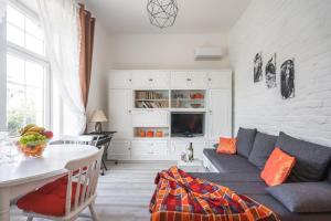 a living room with a couch and a table at Katica's Ribnjak Retreat in Zagreb