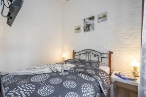 a bedroom with a black and white bed with two pillows at Katica's Ribnjak Retreat in Zagreb