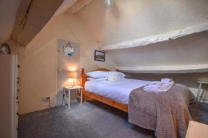 a bedroom with a large bed in an attic at Duke's House, Penrith - Stunning Large Home - Town Centre on your Doorstep - 5 Bedrooms & Sun Trap Garden - Lake District Stay in Penrith