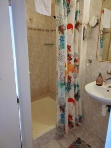 a bathroom with a shower and a sink at Delux Kolonada in Karlovy Vary