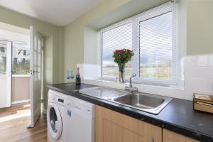 a kitchen with a sink and a washing machine at HC Property - The Hideaway at Watergate Eye in Durham +33 photos