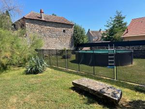 a fence with a bench in a yard at Gîte de l 'Angeline in Bissey-sous-Cruchaud +7 photos