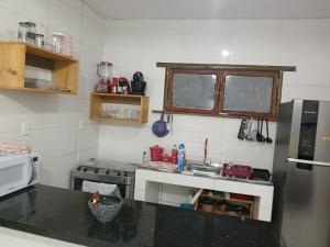 a small kitchen with a sink and a refrigerator at River House in Marau
