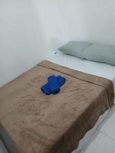 a pair of blue slippers sitting on a bed at River House in Marau
