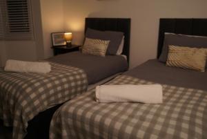 two beds sitting next to each other in a room at Harborne Park House in Birmingham