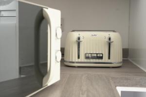 a toaster sitting on the floor in a kitchen at Harborne Park House in Birmingham