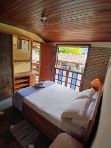 Katil atau katil-katil dalam bilik di Casa em condominio Itaparica