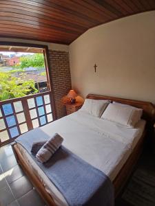 Katil atau katil-katil dalam bilik di Casa em condominio Itaparica