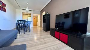 a living room with a large flat screen tv at Vilamar VyB in Denia