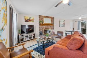 a living room with a couch and a fireplace at The Garnet Goliath Columbias Biggest BnB Yard in Columbia