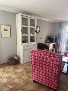 a living room with a white cabinet and a couch at Ferienwohnung Wiesenblick in Westerland (Sylt)