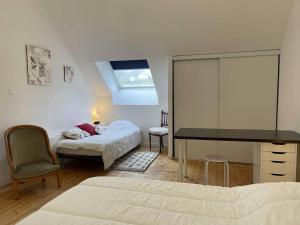 a bedroom with a desk and a bed with a piano at Appartement 3 étoiles à Perros-Guirec avec parking et animaux admis - FR-1-368-75 in Perros-Guirec