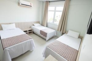 Postel nebo postele na pokoji v ubytování CALLAI HOTEL
