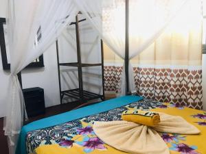 a bed with a banana sitting on top of it at Dinesh House in Weligama