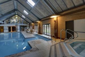 a large indoor swimming pool with a large pool at Knights Hill Hotel & Spa in King's Lynn