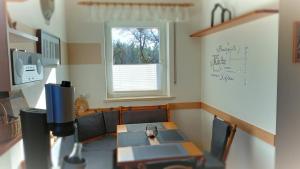 a dining room with a table and a window at Ferienwohnung Pinzenhof - Kemnath in Kemnath