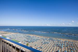 a beach with a lot of umbrellas and the ocean at Hotel Caravelle - Nuova Gestione 2026 in Cattolica