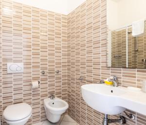 a bathroom with a toilet and a sink at Hotel Caravelle - Nuova Gestione 2026 in Cattolica +151 photos