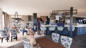 a rendering of a restaurant with people sitting at a bar at Slottsgården Hotell & Restaurang in Vadstena