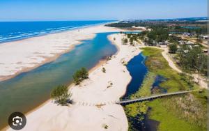 an aerial view of a beach with the ocean at Paraíso chama in Jaguaruna