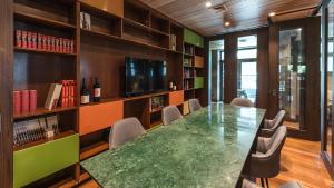 a conference room with a large green table and chairs at Courtyard by Marriott Puerto Montt in Puerto Montt