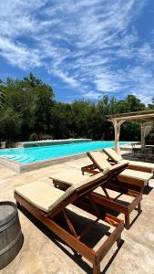 a group of lounge chairs and a swimming pool at Casa Boutique con piscina y cercana a plaza de Villa de las Rosas in Villa de Las Rosas